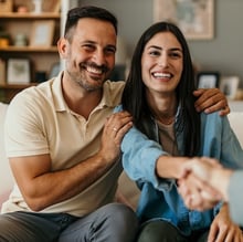 Happy couple shaking hands closing their mortgage